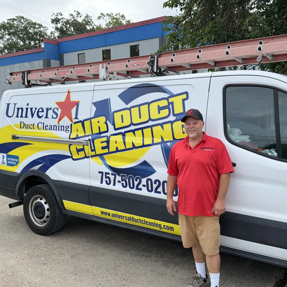 Jacob, a Universal Duct Cleaning technician, standing beside a branded Universal air duct cleaning van in Hampton Roads